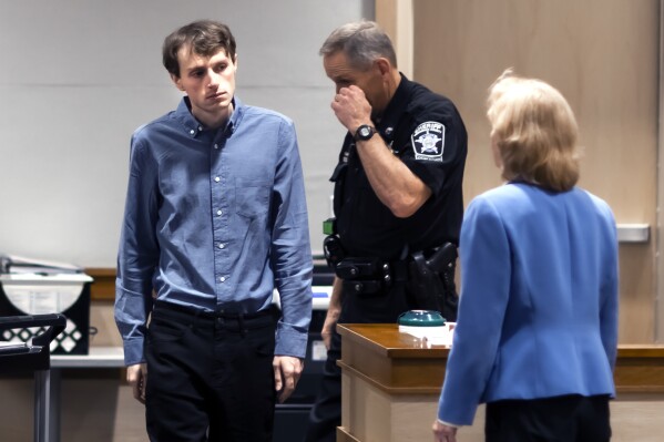 Logan Clegg enters the courtroom at Merrimack County Superior Court, Tuesday, Oct. 3, 2023, in Concord, N.H. Clegg is accused in the shooting deaths of Steve and Wendy Reid in April of 2022. (Geoff Forester/The Concord Monitor via AP, Pool)