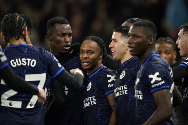 Chelsea's Raheem Sterling, center, celebrates after scoring the opening goal during the English Premier League soccer match between Manchester City and Chelsea at the Etihad stadium in Manchester, England, Saturday, Feb. 17, 2024. (APPhoto/Dave Thompson)