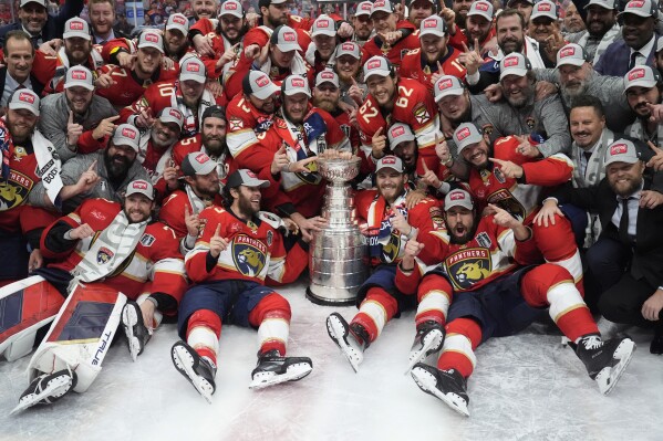 The Florida Panthers team poses with the Stanley Cup trophy after defeating the Edmonton Oilers in Game 7 of the NHL hockey Stanley Cup Final, Monday, June 24, 2024, in Sunrise, Fla. The Panthers defeated the Oilers 2-1. (ĢӰԺ Photo/Wilfredo Lee)