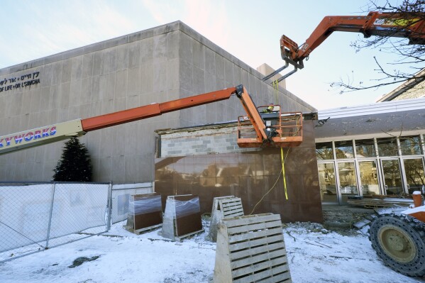 Workers begin demolition Wednesday, Jan. 17, 2023, at the Tree of Life building in Pittsburgh, the site of the deadliest antisemitic attack in U.S. history, as part of the effort to reimagine the building to honor the 11 people who were killed there in 2018. The demolition work began slowly, with crews picking away at the building's exterior. Most the building will be removed, although portions of the sanctuary walls will be preserved. (AP Photo/Gene J. Puskar)