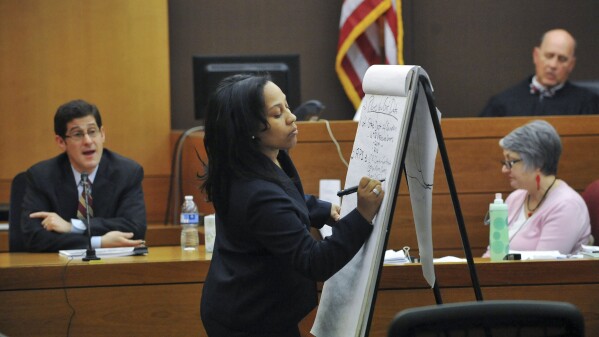 FILE - Fulton County Chief Senior Assistant District Attorney Fani Willis takes notes while questioning University of Michigan professor Brian Jacob, a statistical analysis expert, as he testifies in a case against a group of Atlanta public school educators accused in a scheme to inflate students’ standardized test scores in Fulton County Superior Court, Ga., Feb. 10, 2015. Willis' most prominent case as an assistant district attorney was a RICO prosecution against the group of educators. After a seven-month trial, a jury in April 2015 convicted 11 of them on the racketeering charge. (Kent D. Johnson/Atlanta Journal-Constitution via AP, File)