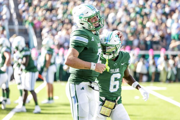 Tulane quarterback Michael Pratt (7) celebrates with wide receiver Lawrence Keys III (6) after a touchdown against North Texas during the first half of an NCAA college football game in New Orleans, Saturday, Oct. 21, 2023. (AP Photo/Derick Hingle)