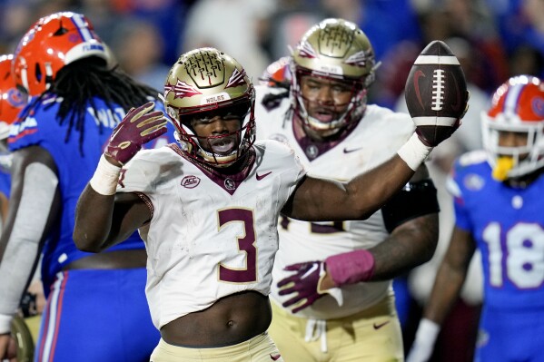 Florida State running back Trey Benson (3) celebrates his 1-yard touchdown run against Florida during the first half of an NCAA college football game Saturday, Nov. 25, 2023, in Gainesville, Fla. (AP Photo/John Raoux)