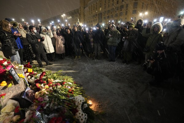 People wave their mobile phone with flashing lights paying their last respect to jailed Russian opposition leader Alexei Navalny at the Memorial to Victims of Political Repression in St. Petersburg, Russia on Friday, Feb. 16, 2024. (AP Photo/Dmitri Lovetsky)