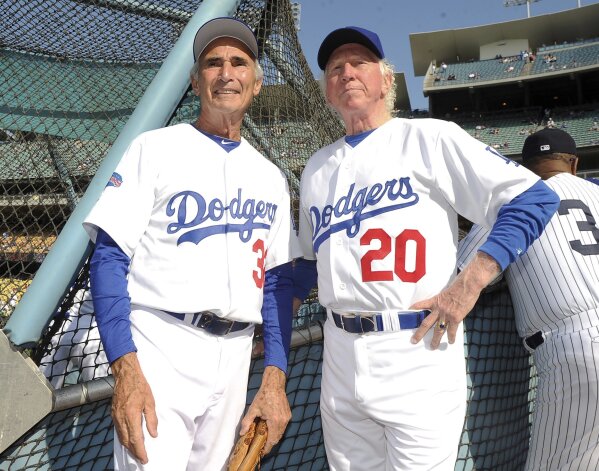 This June 8, 2013, photo shows Hall of Fame and former Los Angeles Dodgers pitcher Don Sutton, right, and Brooklyn Dodger pitcher Sandy Koufax, left, during the Old-Timers game prior to a baseball game between the Atlanta Braves and the Los Angeles Dodgers in Los Angeles. Sutton, a Hall of Fame pitcher who spent most of his career in a Los Angeles Dodgers' rotation that included Koufax and Don Drysdale, has died, Tuesday, Jan. 19, 2021. He was 75. (Keith Birmingham/The Orange County Register via AP, File)