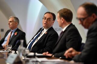 FILE - From left, Deputy Governor for Monetary Policy Ben Broadbent, Governor of the Bank of England Andrew Bailey, Chief Press Officer Sebastian Walsh and Deputy Governor for Markets and Banking Dave Ramsden attend the Bank of England Monetary Policy Report press conference at the Bank of England, London, Thursday Nov. 4, 2021. The Bank of England is likely to raise its key interest rate for the third time since December. It is pushing ahead faster than other central banks in combating a global wave of inflation fueled by soaring energy prices. Economists expect the Bank of England to boost its key rate to 0.75% on Thursday, March 17, 2022 after the war in Ukraine pushed oil prices to a 13-year high earlier this month. (Justin Tallis/Pool via AP, File)