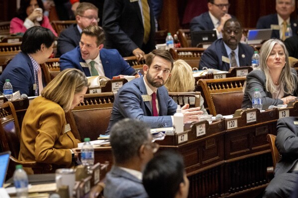 State Rep. Houston Gaines, R-Athens, watches the voting board during the vote for HB 1105, which would penalize sheriffs who don't coordinate with federal immigration authorities, at the House of Representatives in Atlanta on Thursday, Feb. 29, 2024. (Arvin Temkar/Atlanta Journal-Constitution via AP)