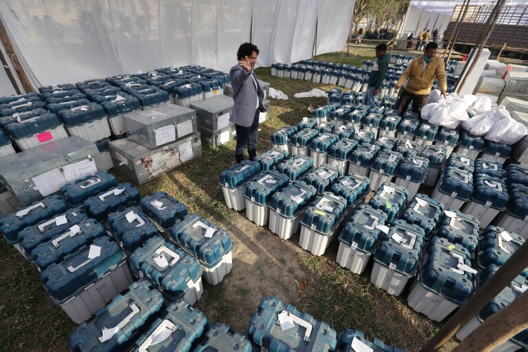 FILE-Election officials gather at a distribution center to receive electronic voting machines and other polling material on the eve of the fourth phase of polling for Uttar Pradesh state elections in Lucknow, India, Tuesday, Feb. 22, 2022. (From April 19 to June 1, nearly 970 million Indians - or over 10% of the world’s population - will vote in the country's general elections. The mammoth electoral exercise is the biggest anywhere in the world - and will take 44 days to complete before results are announced on June 4. (AP Photo/Rajesh Kumar Singh, File)