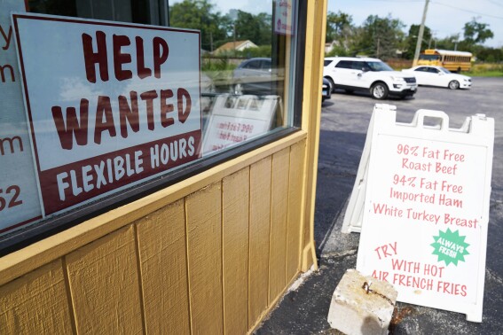 FILE - A "Help Wanted" sign is displayed in Deerfield, Ill., Wednesday, Sept. 21, 2022. The year looks to be a much better one for the U.S. economy than business economists were forecasting just a few months earlier, according to a survey released Monday, Feb. 26, 2024. (AP Photo/Nam Y. Huh)