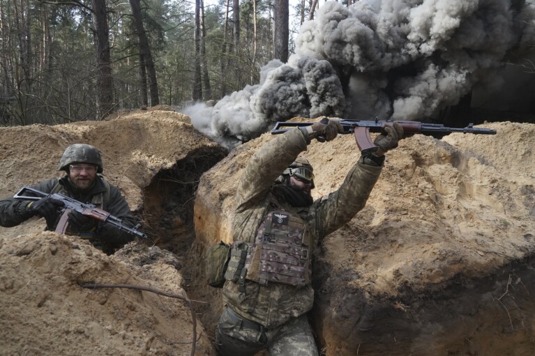 FILE - Ukrainian National Guard soldiers simulate an assault during tactical training at a shooting range in Ukraine’s Kharkiv region on Feb. 29, 2024. (AP Photo/Andrii Marienko, File)