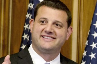 FILE - In this Jan. 6, 2015, file photo, Rep. David Valadao, R-Calif., poses during a ceremonial re-enactment of his swearing-in ceremony in the Rayburn Room on Capitol Hill in Washington. Valadao has reclaimed the U.S. House seat he lost in the California farm belt two years ago. (AP Photo/Jacquelyn Martin, File)