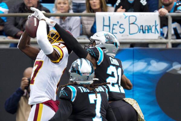 Washington Football Team wide receiver Terry McLaurin scores against Carolina Panthers free safety Jeremy Chinn during the first half of an NFL football game Sunday, Nov. 21, 2021, in Charlotte, N.C. (AP Photo/Jacob Kupferman)