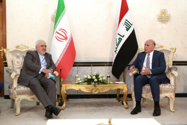 Iraqi Foreign Minister Fuad Hussein, right, meets with visiting Iranian counterpart Mohammad Javad Zarif in Baghdad, Iraq, Sunday, July 19, 2020. (AP Photo/Hadi Mizban)