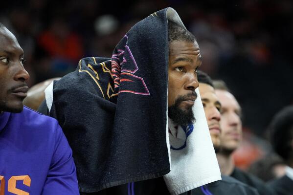 Phoenix Suns forward Kevin Durant watches from the bench during the second half of Game 6 of an NBA basketball Western Conference semifinal series against the Denver Nuggets, Thursday, May 11, 2023, in Phoenix. The Nuggets eliminated the Sun in their 125-100 win. (AP Photo/Matt York)