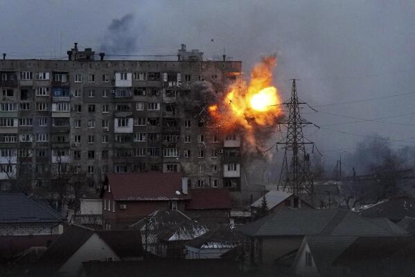 FILE - An explosion is seen in an apartment building after Russian's army tank fires in Mariupol, Ukraine, Friday, March 11, 2022. (AP Photo/Evgeniy Maloletka, File)