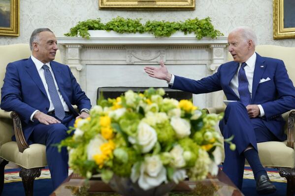 President Joe Biden, right, speaks as Iraqi Prime Minister Mustafa al-Kadhimi, left, listens during their meeting in the Oval Office of the White House in Washington, Monday, July 26, 2021. (AP Photo/Susan Walsh)