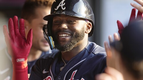 Atlanta Braves' Michael Harris II is congratulated in the dugout after his home run in the third inning of a baseball game against the Cleveland Guardians, Monday, July 3, 2023, in Cleveland. (AP Photo/Sue Ogrocki)