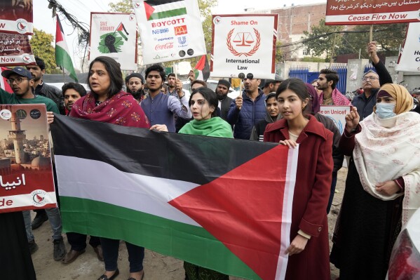 Pakistani people hold placards during a protest against Israeli airstrikes and to show solidarity with Palestinian people in Gaza, in Lahore, Pakistan, Saturday, Feb. 3, 2024. (AP Photo/K.M. Chaudary)