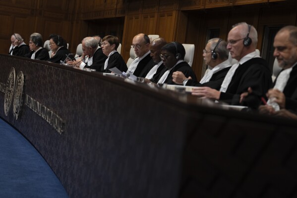 FILE - Presiding judge Joan Donoghue, center, opens preliminary hearings in a case at the International Court of Justice, or World Court, in The Hague, Netherlands, Thursday, Oct. 12, 2023. Lawyers for Azerbaijan on Monday urged the top United Nations court to throw out a case filed by Armenia linked to the long-running dispute over the Nagorno-Karabakh region, arguing that judges do not have jurisdiction. (AP Photo/Peter Dejong, File)