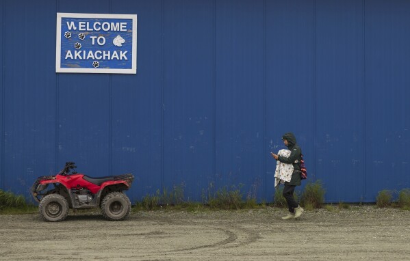 A villager arrives at the airport before boarding a flight, Friday, Aug. 18, 2023, in Akiachak, Alaska. (AP Photo/Tom Brenner)