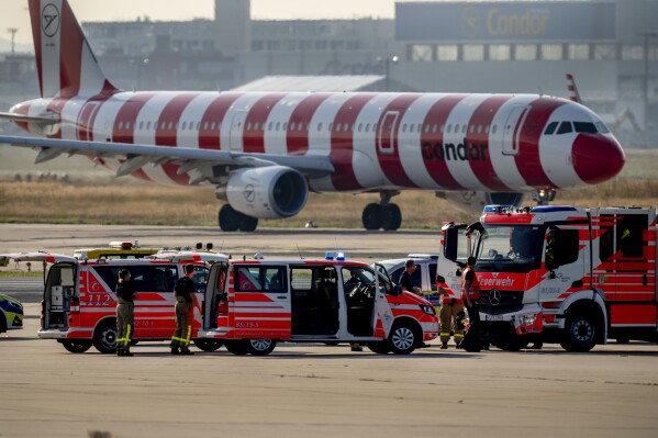Emergency vehicles stand on a runway at the airport in Frankfurt, Germany, Thursday, July 25, 2024, after a few climate activists glued themselves to the ground blocking air traffic for several hours. (ĢӰԺ Photo/Michael Probst)