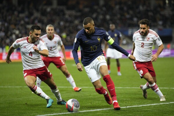 France's Kylian Mbappe, centre, is in action during the Euro 2024 group B qualifying soccer match between France and Gibraltar in Nice, France, Saturday, Nov. 18, 2023. (AP Photo/Daniel Cole)