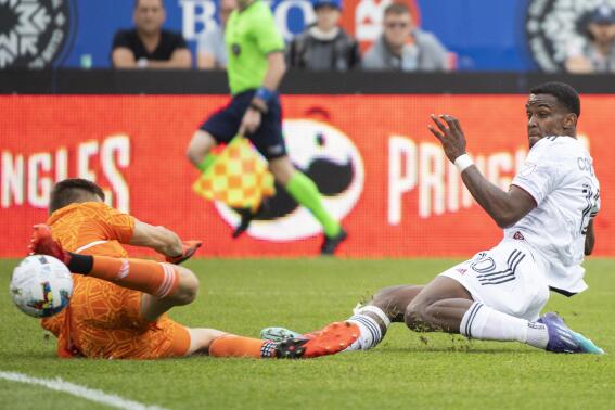 CF Montreal's goalkeeper Sebastian Breza makes a save against Real Salt Lake's Sergio Cordova during the second half of an MLS soccer game in Montreal, Sunday, May 22, 2022. (Graham Hughes/The Canadian Press via AP)
