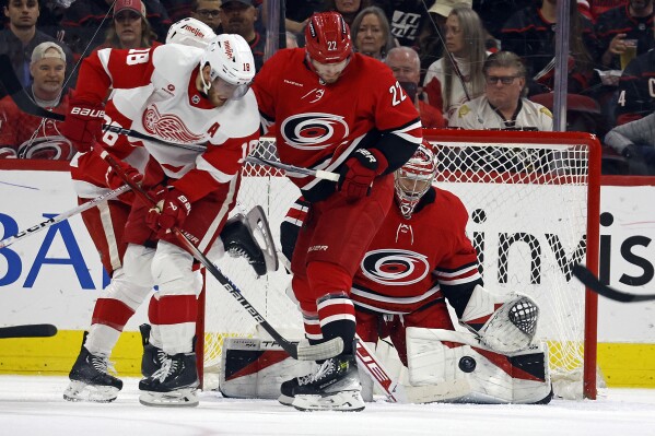 Carolina Hurricanes goaltender Frederik Andersen cleans up the puck behind teammate Brett Pesce (22) and Detroit Red Wings' Andrew Copp during the second period of an NHL hockey game in Raleigh, N.C., Thursday, March 28, 2024. (AP Photo/Karl B DeBlaker)