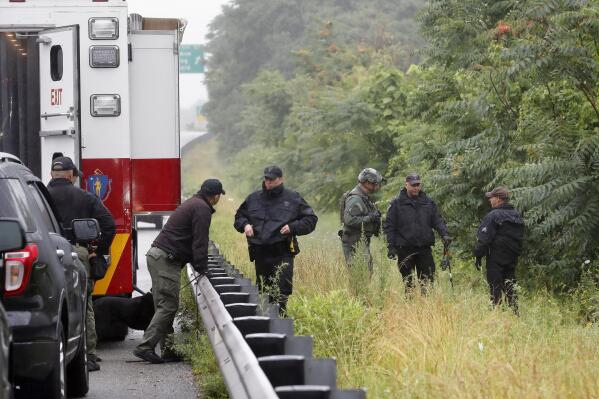 Police work in the area of an hours long standoff with a group of armed men that partially shut down interstate 95, Saturday, July 3, 2021, in Wakefield, Mass. (AP Photo/Michael Dwyer)