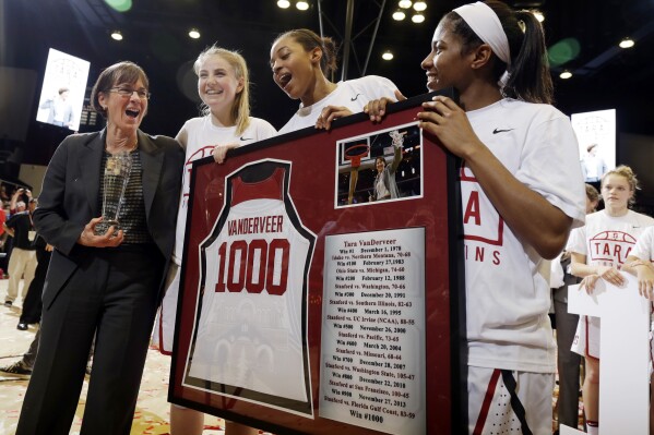 FILE - Stanford coach Tara VanDerveer, left, celebrates with her players, including Karlie Samuelson, second from left, Erica McCall, center, and Briana Roberson, after her 1,000th career coaching win following an NCAA college basketball game against Southern California on Friday, Feb. 3, 2017, in Stanford, Calif. VanDerveer, the winningest basketball coach in NCAA history, announced her retirement Tuesday night, April 9, 2024, after 38 seasons leading the Stanford women’s team and 45 years overall. (AP Photo/Marcio Jose Sanchez, File)