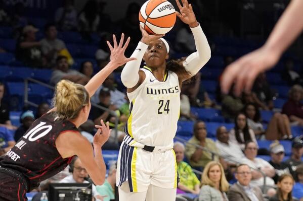 Indiana Fever guard Lexie Hull (10) defends as Dallas Wings guard Arike Ogunbowale (24) shoots a 3-pointer during the first half of a WNBA basketball game Thursday, June 23, 2022, in Arlington, Texas. (AP Photo/Tony Gutierrez)