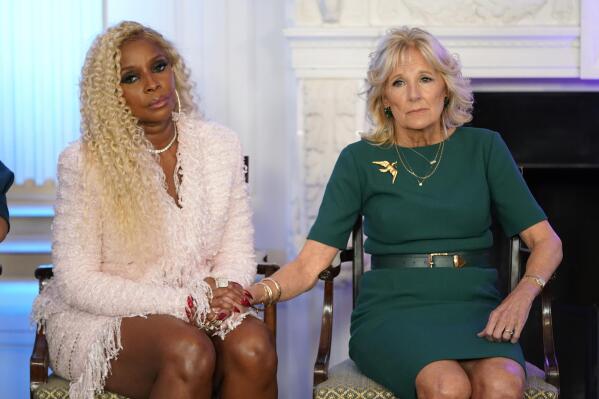 First lady Jill Biden holds hands with singer Mary J. Blige during an event to launch the American Cancer Society's national roundtables on breast and cervical cancer in the State Dining Room of the White House, Monday, Oct. 24, 2022, in Washington. (AP Photo/Patrick Semansky)