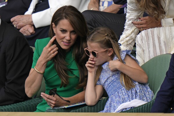 Kate, Princess of Wales chats with Princess Charlotte as they sit in the Royal Box on Centre Court for the final of the men's singles between Spain's Carlos Alcaraz and Serbia's Novak Djokovic on day fourteen of the Wimbledon tennis championships in London, Sunday, July 16, 2023. (AP Photo/Alastair Grant)