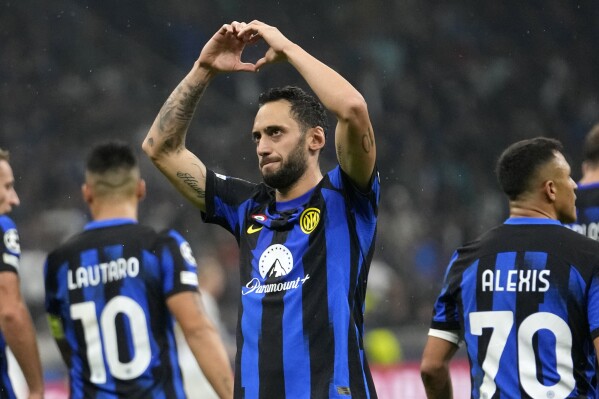 Inter Milan's Hakan Calhanoglu celebrates after scoring a penalty, his side's second goal, during the Champions League, Group D soccer match between Inter Milan and Salzburg, at the San Siro stadium in Milan, Italy, Wednesday, Oct. 24, 2023. (AP Photo/Luca Bruno)