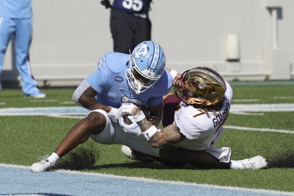 North Carolina wide receiver Nate McCollum (6) catches a touchdown pass against Minnesota defensive back Aidan Gousby (7) during the first quarter of an NCAA college football game, Saturday, Sept. 16, 2023, in Chapel Hill, N.C. (AP Photo/Reinhold Matay)