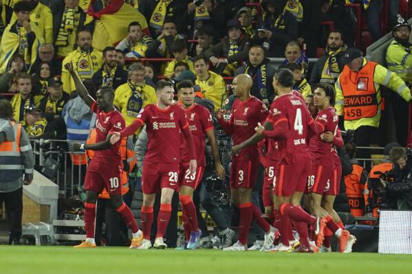 Liverpool's Sadio Mane, left, celebrates after scoring his side's second goal during the Champions League semi final, first leg soccer match between Liverpool and Villarreal at Anfield stadium in Liverpool, England, Wednesday, April 27, 2022. (AP Photo/Jon Super)
