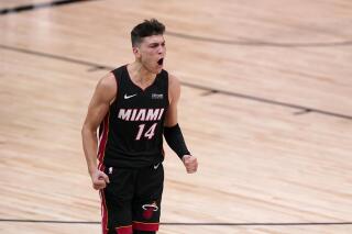 FILE - Miami Heat guard Tyler Herro (14) celebrates a basket against the Boston Celtics late in the second half of Game 4 of an NBA basketball Eastern Conference final in Lake Buena Vista, Fla., in this Wednesday, Sept. 23, 2020, file photo. The Miami Heat guard was preparing to become a father for the first time and if that wasn’t enough, he’d see his name linked to trades all over Twitter along with unfounded rumors about his personal life and how he wasn’t taking basketball seriously. It wasn’t fun. But those days, he believes, are over. The baby is here, his head is clear and as Heat camp looms, Herro says he’s planning for this to be his best season. (AP Photo/Mark J. Terrill, File)