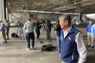 Georgia Gov. Brian Kemp walks to board an airplane Tuesday, May 11, 2021 at DeKalb-Peachtree Airport in Chamblee, Ga. Kemp announced he was suspending state taxes on gasoline and diesel through Saturday to give price relief following a pipeline outage. (AP Photo/Jeff Amy)