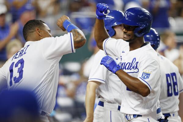 Kansas City Royals' Salvador Perez (13) congratulates Michael A. Taylor, right, after hitting a home run during the fifth inning of a baseball game against the Seattle Mariners at Kauffman Stadium in Kansas City, Mo., Saturday, Sept. 18, 2021. (AP Photo/Colin E. Braley)