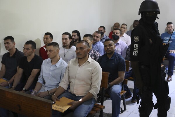 Colombians and Haitians who are suspects and accused of involvement in the 2021 assassination of Haitian President Jovenel Moise sit in handcuffs at court in Port-au-Prince, Haiti, Monday, Jan. 13, 2025. (AP Photo/Odelyn Joseph)
