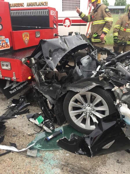 FILE - In this Friday, May 11, 2018, file photo, released by the South Jordan Police Department shows a traffic collision involving a Tesla Model S sedan with a Fire Department mechanic truck stopped at a red light in South Jordan, Utah. (South Jordan Police Department via AP, File)