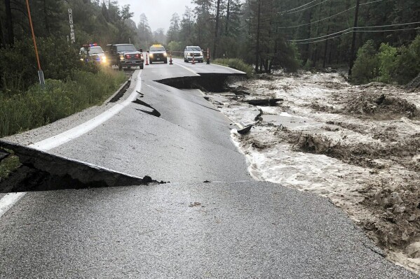 FILE - This image provided by the Mount Charleston Fire Protection District via the Clark County, Nev., Public Information Office shows an asphalt road separated in Mount Charleston, Nev., Monday, Aug. 21, 2023, after upwards of five inches of rain battered the area west of Las Vegas from Tropical Storm Hilary. After nearly two months of repairs, authorities have reopened the first of three state storm-damaged highways that provide primary access for residential enclaves and recreation areas on Mount Charleston in the Las Vegas area. (Mount Charleston Fire Protection District/Clark County, Nev., Public Information Office via AP, File)