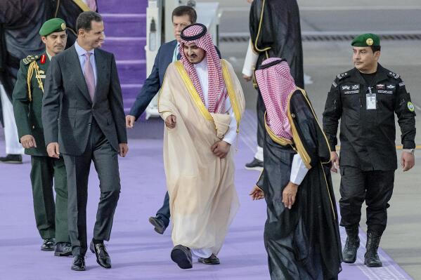 In this photo provided by Saudi Press Agency, SPA, Syrian President Bashar Assad, is accompanied by Prince Badr Bin Sultan, the deputy governor of Mecca, upon his arrival at Jeddah airport, Saudi Arabia, Thursday, May 18, 2023, ahead of the Arab summit. (Saudi Press Agency via AP)