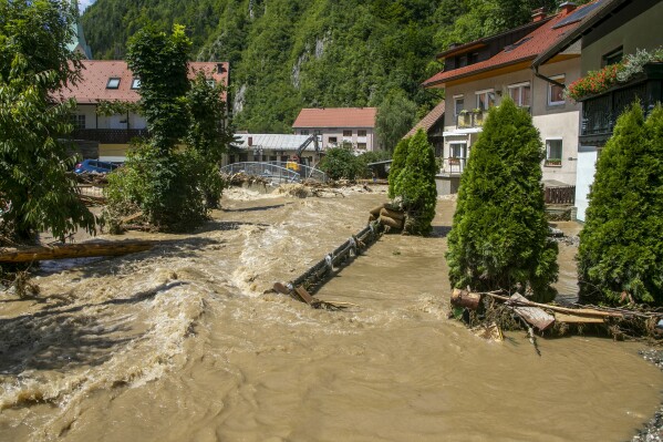 A flooded area is seen in Crna na Koroskem, Slovenia, Sunday, Aug. 6, 2023. The floods were caused by torrential rains on Friday which caused rivers to swell swiftly and burst into houses, fields and towns. Slovenia's weather service said a month's worth of rain fell in less than a day. Experts say extreme weather conditions are partly fueled by climate change. (AP Photo)