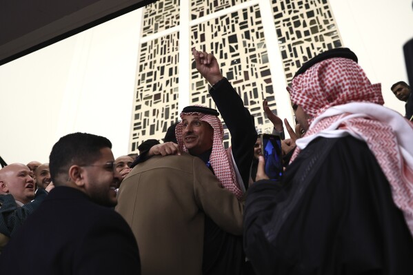 Members of the Saudi Arabia delegation react as the Bureau International des Expositions, or BIE, announces the vote Tuesday, Nov. 28, 2023 in Issy-les-Moulineaux, outside Paris. Saudi Arabia's capital Riyadh was chosen to host the 2030 World Expo, beating out South Korean port city Busan and Rome for an event expected to draw millions of visitors. Saudi Arabia's capital Riyadh was chosen on Tuesday to host the 2030 World Expo, beating out South Korean port city Busan and Rome for an event expected to draw millions of visitors. Riyadh was picked by a majority of 119 out of 165 votes by the member states. (AP Photo/Aurelien Morissard)