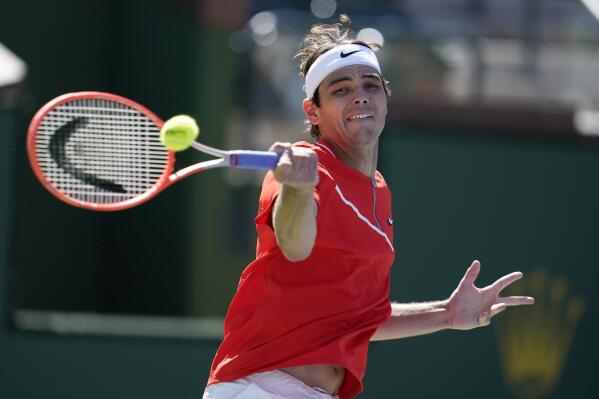 Taylor Fritz returns to Jaume Munar of Spain, at the BNP Paribas Open tennis tournament Tuesday, March 15, 2022, in Indian Wells, Calif. (AP Photo/Marcio Jose Sanchez)