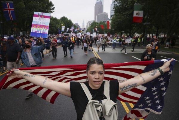 Demonstrators march down Benjamin Franklin Parkway during the "No Kings" protest, Saturday, June 14, 2025, in Philadelphia. (AP Photo/Yuki Iwamura)