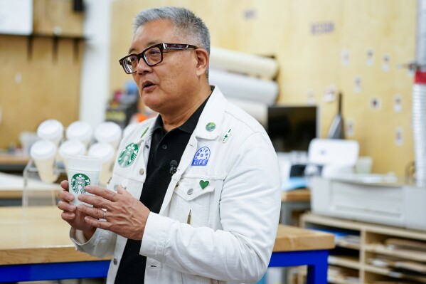 Starbucks Chief Sustainability Officer Michael Kobori holds a reusable cup used in a new "Borrow-a-Cup" program during an interview at the Tryer Center at Starbucks headquarters, Wednesday, June 28, 2023, in Seattle. "Our vision for the cup of the future — and our Holy Grail, if you will — is that the cup still has the iconic symbol on it," says Michael Kobori, head of sustainability at Starbucks. "It's just as a reusable cup." (AP Photo/Lindsey Wasson)