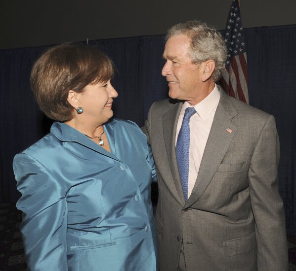 FILE - In a Tuesday, May 24, 2011 file photo, former Louisiana Gov. Kathleen Blanco greets former President George W. Bush in Lafayette, La.  Louisiana Gov. John Bel Edwards’ office confirmed former Louisiana Gov. Kathleen Babineaux Blanco, who became the state’s first female elected governor, died Sunday, Aug. 18, 2019. She was 76. (P.C. Piazza/The Daily Advertiser via AP)