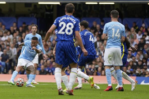 Manchester City's Gabriel Jesus, left, scores his side's opening goal during the English Premier League soccer match between Chelsea and Manchester City at Stamford Bridge Stadium in London, Saturday, Sept. 25, 2021. (AP Photo/Alastair Grant)